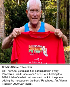 Bill Thorn holds 2020 Peachtree Road Race shirt