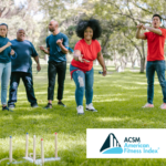 team of people in blue shirts playing ring toss in a park against a team of people wearing red shirts